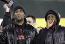 Miami Heat players LeBron James , left, and Dwyane Wade share a laugh on the field before the NCAA college football game between Oregon and Southern California in Eugene, Ore., Saturday, Nov. 19, 2011.