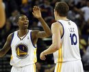 The Golden State Warriors ' Dorell Wright (1) and David Lee celebrate in the closing seconds of their opening night win over the Houston Rockets 132-128 in an NBA  basketball game, Wednesday, Oct. 27, 2010 in Oakland, Calif.