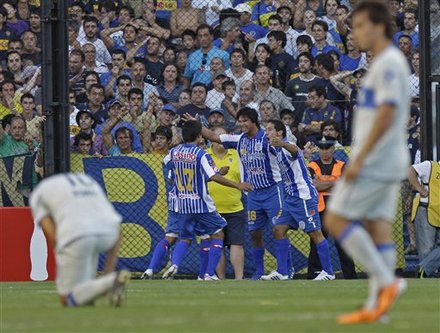 Ruben Ramirez of Argentina's Godoy Cruz, (18) celebrates with teammates after scoring against the Boca Juniors 101 in an Argentine soccer league match in Buenos Aires, Argentina, Sunday Feb. 13, 2011.