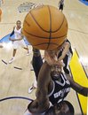 San Antonio Spurs center DeJuan Blair , top, reaches for a rebound with Oklahoma City Thunder forward Jeff Green , bottom, in the first quarter of an NBA basketball game in Oklahoma City, Sunday, Nov. 14, 2010.
