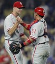 Philadelphia Phillies relief pitcher Ryan Madson , left, is congratulated by catcher Carlos Ruiz (51) for closing out the Los Angeles Dodgers during the ninth inning of a baseball game in Los Angeles, Monday, Aug. 8, 2011. The Phillies won the game 5-3.