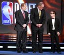 David Kahn, left, general manager of the Minnesota Timberwolves , Kevin O'Connor, center, general manager of the Utah Jazz , and Nick Gilbert, 14, right, the son of Cleveland Cavaliers owner Dan Gilbert, stand on the stage representing the final three teams during the 2011 NBA basketball draft lottery, Tuesday, May 17, 2011 in Secaucus, N.J. The Cavaliers won the lottery.