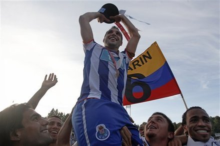 Porto's Team Captain Mariano Gonzalez, From Argentina, Top, Lifts The Trophy With Teammates Falcao, From Colombia, Left,