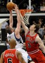 Chicago Bulls ' Omer Asik , right, goes up to block a shot by Minnesota Timberwolves ' Kevin Love during the second half of an NBA basketball game on Wednesday, March 30, 2011, in Minneapolis. The Bulls won 108-91. Love led the Timberwolves with 16 points.