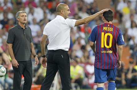 FC Barcelona's Coach Josep Guardiola, Center, Celebrates With Lionel Messi From Argentina, Right, Besides Real Madrid's