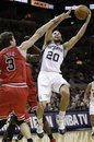 San Antonio Spurs ' Manu Ginobili (20), of Argentina, is defended by Chicago Bulls ' Omer Asik (3), of Turkey, during the second quarter of an NBA basketball game, Wednesday, Nov. 17, 2010, in San Antonio.