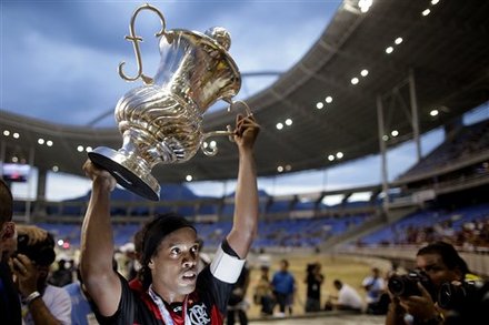 Flamengo's Ronaldinho holds up the Guanabara trophy after Flamengo defeated Boavista 1-0 in the Guanabara Cup final in Rio de Janeiro, Brazil, Sunday, Feb. 27, 2011. The Guanabara Cup is the first stage of the Rio tournament and its winner will play for the Rio state title against the Rio Cup champion.