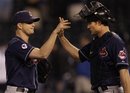 Cleveland Indians relief pitcher Vinnie Pestano , left, is congratulated by catcher Lou Marson , right, following a Major League Baseball game against the Kansas City Royals in Kansas City, Mo., Monday, May 16, 2011. The Indians defeated the Royals 19-1.