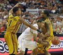 Texas guard Cory Joseph, center, loses the ball against Missouri guard Phil Pressey, left, and guard Marcus Denmon, right, during the second half in an NCAA college basketball game Saturday, Jan. 29, 2011, in Austin, Texas. Texas won 71-58.