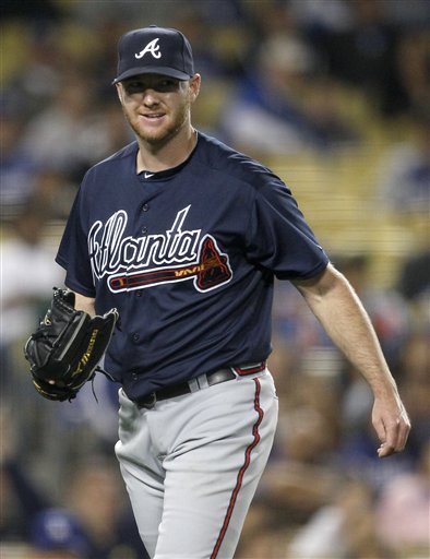 Atlanta Braves relief pitcher Jonny Venters smiles after throwing Los Angeles Dodgers ' Juan Uribe out at first to end the eighth inning of a baseball game in Los Angeles, Tuesday, April 19, 2011.