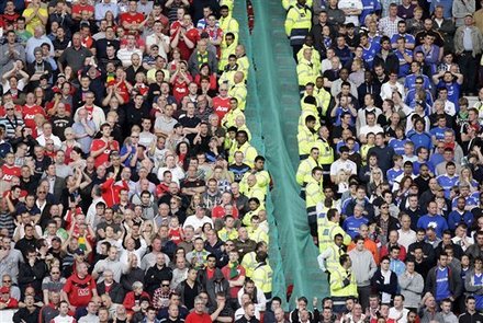 Manchester United and Chelsea fans look on during their English Premier League soccer match at Old Trafford, Manchester, England, Sunday May 8, 2011. (AP Photo/Jon Super) NO INTERNET/MOBILE USAGE WITHOUT FOOTBALL ASSOCIATION PREMIER LEAGUE (FAPL) LICENCE. CALL +44 (0) 20 7864 9121 or EMAIL info@football-dataco.com FOR DETAILS