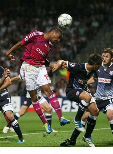 Lyon's French Forward Jimmy Briand, Left,  Jumps