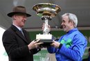 Trainer Willie Mullins, left, and jockey Ruby Walsh hold the trophy after Hurricane Fly won the Champion Hurdle at the Cheltenham Horse Racing Festival, Cheltenham, England, Tuesday March 15, 2011. (AP Photo/PA, David Davies) UNITED KINGDOM OUT NO SALES NO ARCHIVE