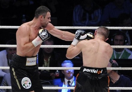 WBC Heavyweight World Champion Vitali Klitschko Of Ukraine, Left, Fights With Punches  Challenger Tomasz Adamek From