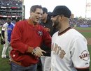 San Francisco 49ers Hall of Famer Steve Young, left, greets San Francisco Giants outfielder Cody Ross , right, after throwing out a ceremonial first pitch before the Giants' baseball game against the St. Louis Cardinals in San Francisco, Saturday, April, 9, 2011.