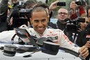 Formula One driver Lewis Hamilton gets into NASCAR driver Tony Stewart 's car during the Mobil 1 Car Swap auto race event in Watkins Glen, N.Y., Tuesday, June 14, 2011.