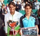 Rafael Nadal of Spain, left, and  David Ferrer of Spain hold their trophies after Nadal defeated Ferrer in the final match of the Monte Carlo Tennis Masters tournament in Monaco, Sunday, April 17, 2011.