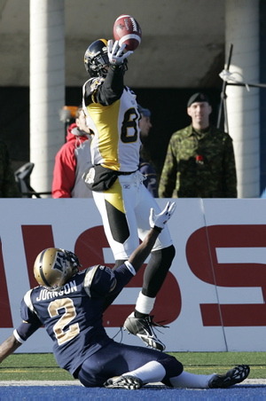 Hamilton Tiger-Cats' Prechae Rodriguez (85) bobbles the pass in the Winnipeg Blue Bombers end zone against Jovon Johnson (2) in first half CFL action in Winnipeg, Sunday, November 8, 2009. THE CANADIAN PRESS/John Woods