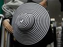 ELMONT, NY - JUNE 11: A woman adjust her hat prior to the running of the 143rd Belmont Stakes at Belmont Park on June 11, 2011 in Elmont, New York. (Photo by Rob Carr/Getty Images)