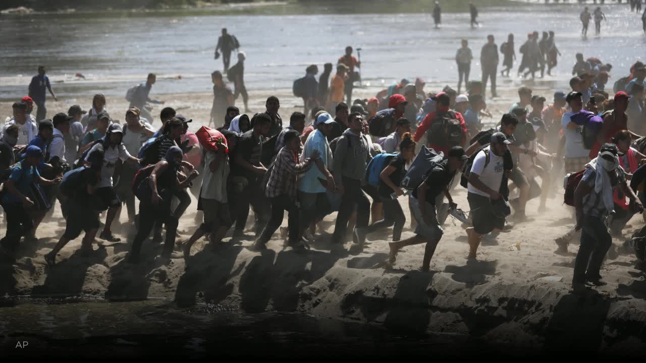 Migrants tear-gassed as they try to storm into Mexico