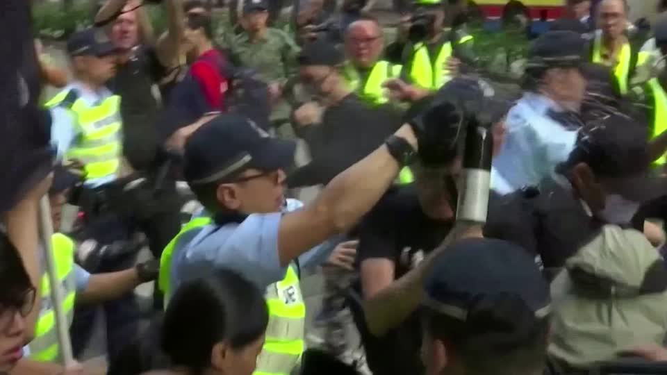Early scuffles met with pepper spray in Hong Kong