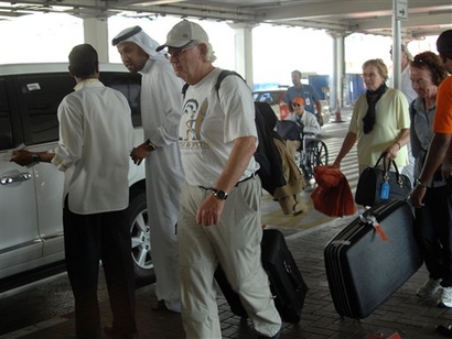 In this Dec. 10, 2008 file photo passengers from the MS Columbus cruise ship prepare to board a bus on arrival in Dubai by chartered flight after they disembarked  in Yemen, in fear of a Somalian pirate attack in the Gulf. (AP Photo/ Aziz Shah, File)