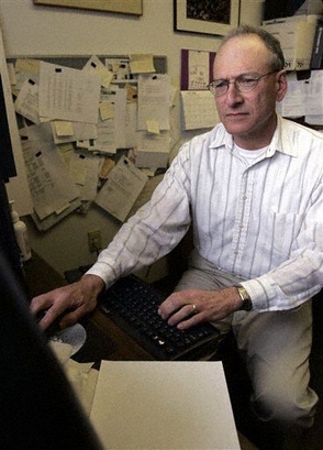 **FILE PHOTO** Wayne State University economics professor Allen Goodman works in his office in Detroit May 15 2006. When it comes to health benefits the news has been largely glum for workers approaching retirement. But Wayne State has formed a joint committee with the faculty union to study the feasibility of adding university-subsidized health insurance for retirees. Goodman is one of the union representatives on the joint committee studying the issue. He said he never considered going without coverage to supplement Medicare in retirement. (AP Photo/Carlos Osorio)