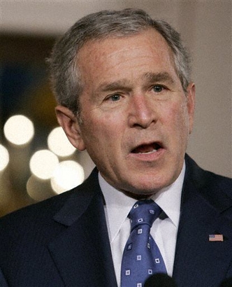 **FILE PHOTO** President Bush answers a reporter's question in the Cross Hall of the White House in Washington, Jan. 4, 2007. (AP Photo/Charles Dharapak)