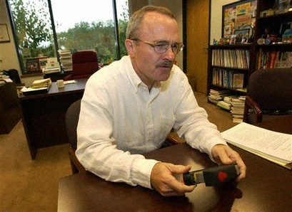 **FILEPHOTO** President and CEO of Staples Ronald L. Sargent shows off a new product during an interview in Framingham, Mass., Aug. 16, 2004.  (AP Photo/Lisa Poole)