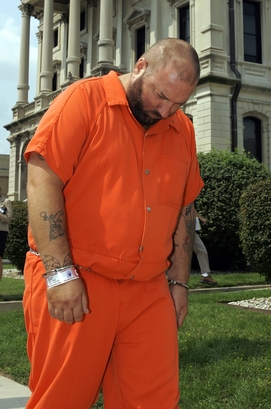 **FILE PHOTO** Robert F. Spencer, 37, is escorted from the Grant County Courthouse in Marion, Ind., Sept. 7, 2006, following a preliminary hearing where he was formally charged with five counts of reckless homicide. Spencer, a Michigan truck driver, is accused of falling asleep at the wheel of his rig and causing a highway crash that killed five people. Authorities said that before the April 26 crash, Spencer fell asleep at the wheel after having driven at least nine hours more than what is allowed under federal rules. (AP Photo/Michael Conroy)