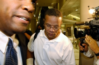 **FILE PHOTO** Vincent Brothers, center, walks past television cameras after arriving at Los Angeles International Airport, July 11, 2003, in Los Angeles.  (AP Photo/Rene Macura)