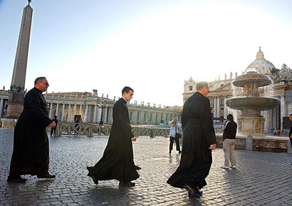 Three priests cross St. Peter's Square at the Vatican, in this Oct. 18, 2002 file photo. (AP Photo/Luciano Del Castillo)