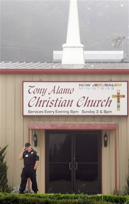 A man patrols in front of the Tony Alamo Christian Church in Fouke, Ark., in this Sept. 21, 2008 photo.  (AP Photo/Danny Johnston)