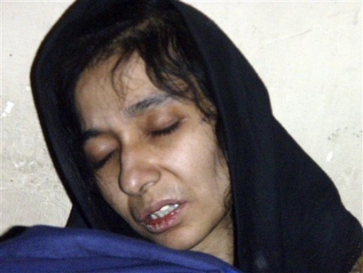In this July 17, 2008 file photo, Aafia Siddiqui, possible Al-Qaida associate, is seen in the custody of Counter Terrorism Department of Ghazni province in Ghazni City, Afghanistan. Siddiqui, 36, is held in federal custody in New York after her arrest outside an Afghan governor's compound where authorities allege she was carrying bottles and jars of chemicals, papers describing U.S. landmarks, and instructions on how to make chemical weapons. Recovering from wounds she sustained in Afghanistan, prosecutors say she was shot by a U.S. Army officer after she grabbed his Army M-4 rifle from the floor and pointed it at an Army captain, crying 'Allah Akbar!' (AP Photo/STR)