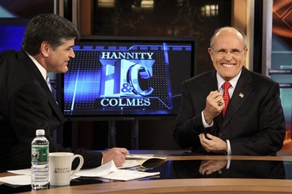 Former New York City Mayor Rudolph Giuliani, right, is seen with Sean Hannity while on the set of Hannity and Colmes on the Fox News Channel in New York on Feb. 5, 2007. (AP Photo/Adam Rountree)