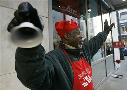 Jerry Manning rings a bell near his Salvation Army red kettle in downtown Seattle in this Nov. 23, 2007 file photo. (AP Photo/Ted S. Warren)