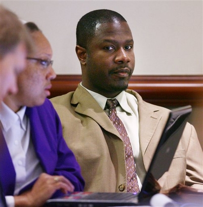 Brian Nichols sits with members of his defense team as the sentencing phase of his trial continues Monday Dec. 1, 2008, at the Atlanta Municipal Court Building in downtown Atlanta. Nichols was found guilty Nov. 7 of murdering a judge, a court reporter, a sheriff's deputy and a federal agent when he escaped from a 2005 rape trial. (AP Photo/Kimberly Smith,Pool)