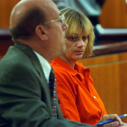Dena Riley, right, listens as public defender Anthony Cardarella addresses the court during her arraignment in Independence, Mo., in this July 19, 2006 file photo. (AP Photo/Jeff Stead, Pool)