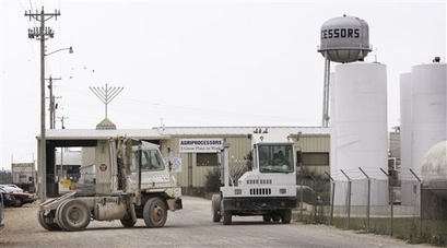 In this July 27, 2008 file photo, trucks sit parked outside the Agriprocessors kosher meat packing plant, in Postville, Iowa. The Iowa Labor Commissioner's Office announced Aug. 5, 2008, that it had uncovered dozens of alleged child labor violations at the plant. (AP Photo/Charlie Neibergall)